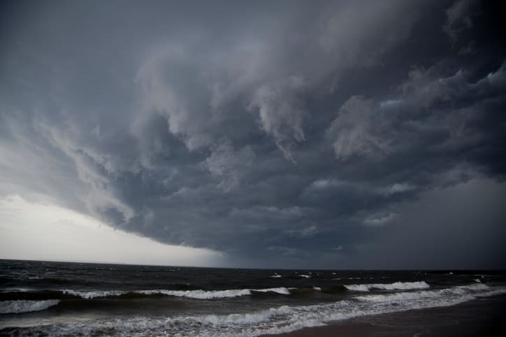 Why do tornadoes often occur after a hurricane lands on land