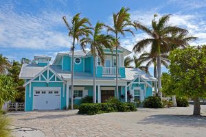 Beautiful floridian home with blue colored facade.