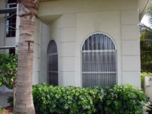 Clear storm panels protecting arched windows 