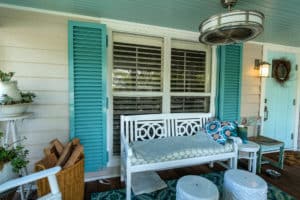 Colonial Shutters Bonita Springs FL Teal blue colonial shutters opened out on a front porch window