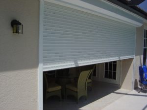 Roll down screen halfway through closing, with outdoor chairs protected behind it 