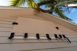 A strap and buckle screen covering a house's window 