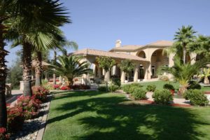 Large Floridian home with a well manicured front garden.