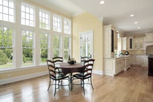 Eating area looks fabulous with natural lights through a wall of windows
