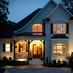 Luxury home looks amazing at night with yellow lights inside windows 