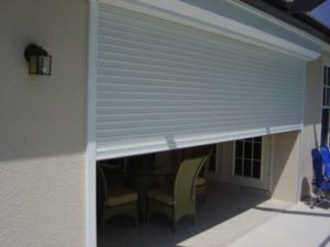 Rolling shutters closing to protect a home's semi-outdoor area