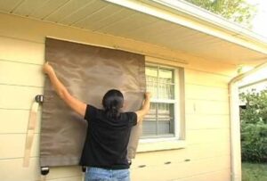 Woman installing a Storm Catcher Easy Screen