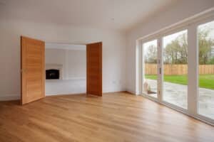 Empty room with large white-framed patio doors